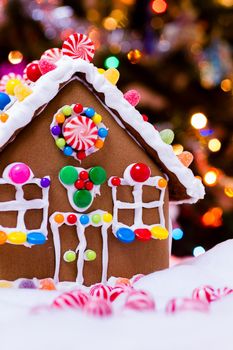 Gingerbread house with round peppermint candies.