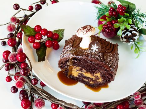 Traditional Christmas Yule Log cake decorated with marzipan mushrooms.