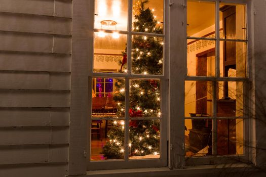 Historic farm decorated with Christmas lights.