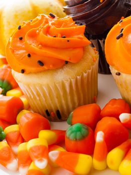 Halloween orange and black cupcakes on white background.