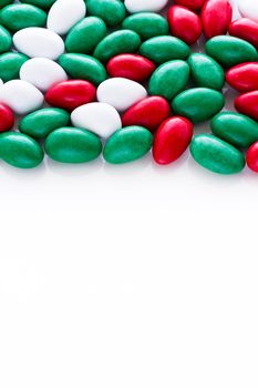 Colorful red, green and white candies on white background.