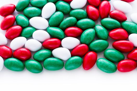 Colorful red, green and white candies on white background.
