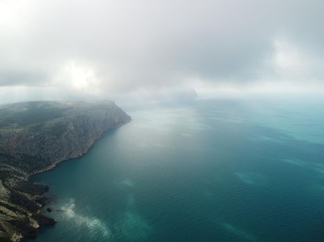 Aerial panoramic view of beautiful sunset above sea. Beautiful seascape. Sun glare, small waves on the water surface. Evening. Horizon. Nobody. No people. Copy space. Never-ending beauty of nature