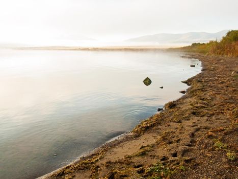 Early morning at the lake with fog in early Fall.