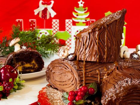 Traditional Christmas Yule Log cake decorated with marzipan mushrooms.