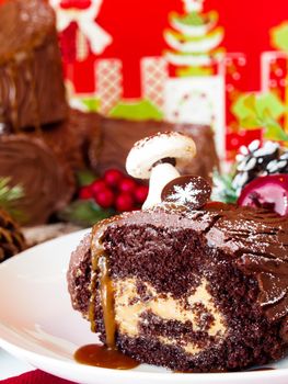 Traditional Christmas Yule Log cake decorated with marzipan mushrooms.