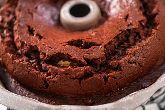 Cooling freshly baked red velvet bundt cake on a kitchen counter.