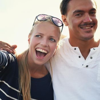 Excited young couple. An excited young couple having a good time outdoors