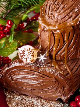 Traditional Christmas Yule Log cake decorated with marzipan mushrooms.