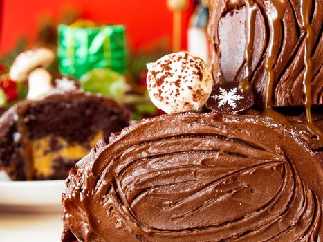 Traditional Christmas Yule Log cake decorated with marzipan mushrooms.