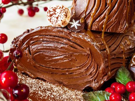 Traditional Christmas Yule Log cake decorated with marzipan mushrooms.