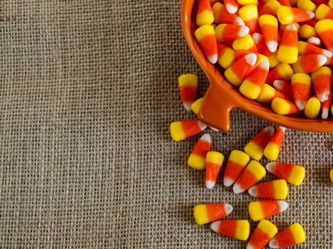 Traditional Halloween candies candy corn in orange bowl.