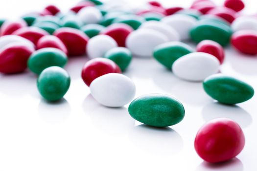 Colorful red, green and white candies on white background.