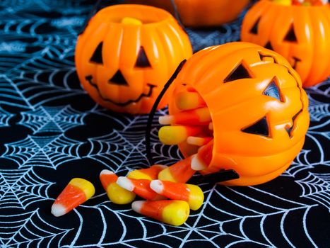 Candy corn candies falling out of Halloween treat bag.