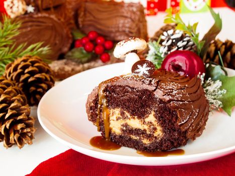 Traditional Christmas Yule Log cake decorated with marzipan mushrooms.