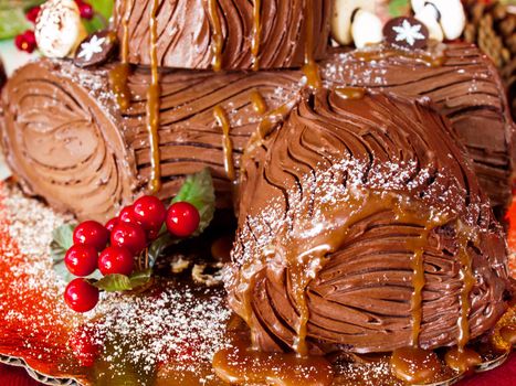 Traditional Christmas Yule Log cake decorated with marzipan mushrooms.