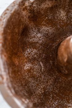 Greasing metal bundt cake pan to red velvet bundt cake with cream cheese glaze.