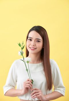 Close up portrait of an attractive young woman holding flower
