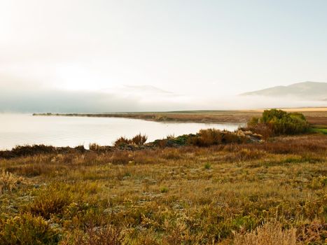 Early morning at the lake with fog in early Fall.