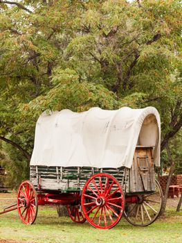 Old wagon with red wheels on display at the historical museum.