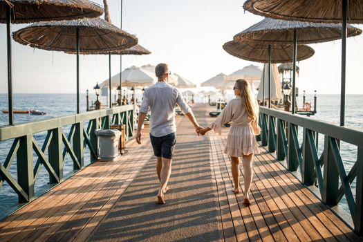 A loving couple is resting at the sea in Turkey. Man and woman on the pier. Sea tour. Honeymoon. Couple on a honeymoon trip. A beautiful couple travels the world. Happy couple on vacation.