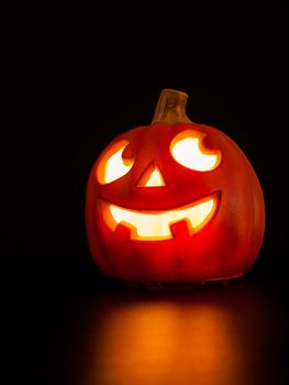 Lit jack-o'-lantern on black background.