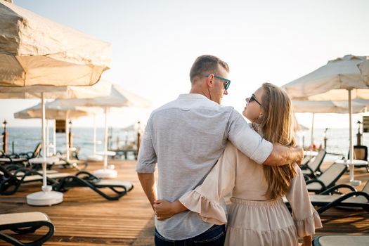 A loving couple is resting at the sea in Turkey. Man and woman on the pier. Sea tour. Honeymoon. Couple on a honeymoon trip. A beautiful couple travels the world. Happy couple on vacation.