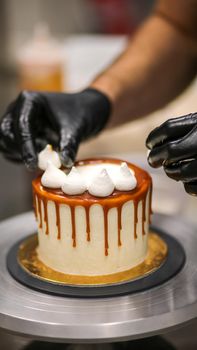 chef decorating the top of a frosted buttercream cake