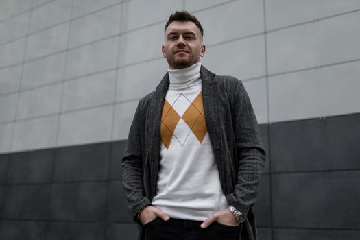 portrait of a brutal young man against a black and white wall.