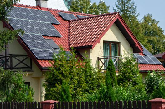 Historic farm house with modern solar panels on roof and wall High quality photo