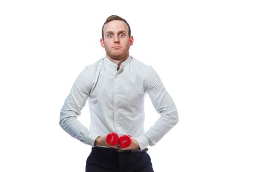 Caucasian man businessman, a teacher involved in sports. He is holding a red dumbbell. He is wearing a shirt. Emotional portrait. Isolated on white background