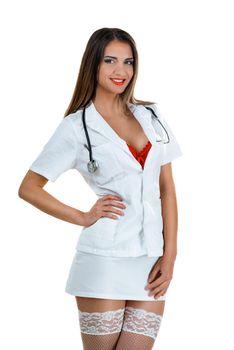 Beautiful smiling sexy female doctor with stethoscope standing and posing in short skirt and stockings thigh high. Isolated on white background. Looking at camera.