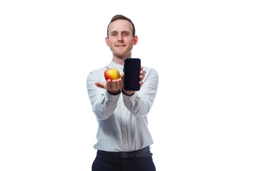 Caucasian male businessman holding a mobile phone in black and holding a red-yellow apple. He is wearing a shirt. Emotional portrait. Isolated on white background