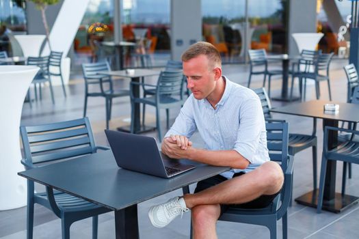 Successful male freelance businessman using laptop computer at work on vacation. Business, study, freelance. Remote work