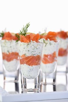 Verrine  from soft cheese cream and salmon, dill sprig and lemon slice. Aperitif appetizer.