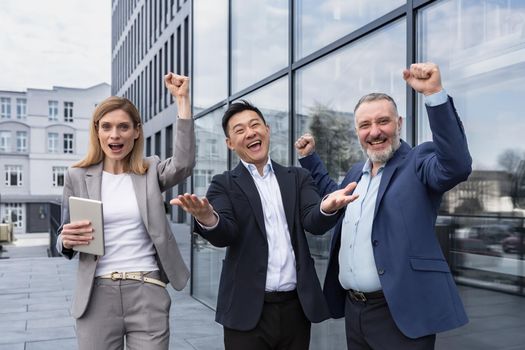 Success Happy Group business people excited rejoicing looking at camera after successful completion project, and smiling Portrait diverse team employees celebrating victory.