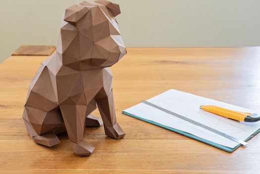 Dog in polygon cubist style on the table. DIY.