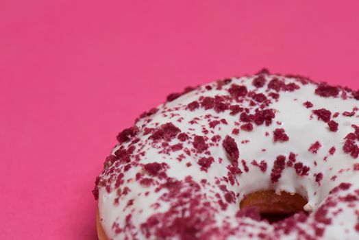 Macro shoot of white donut over pink background.