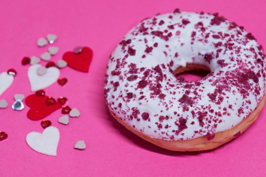 Macro shoot of white chocolate donut over pink background