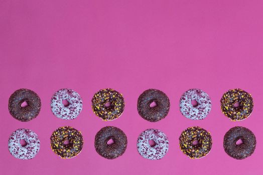 Top view to the donuts over pink background