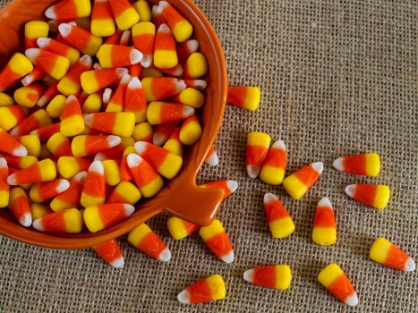 Traditional Halloween candies candy corn in orange bowl.