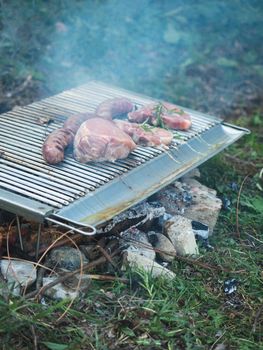 cooking pork meat in the grill outdoors with charcoal