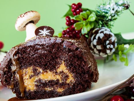 Traditional Christmas Yule Log cake decorated with marzipan mushrooms.