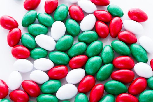 Colorful red, green and white candies on white background.