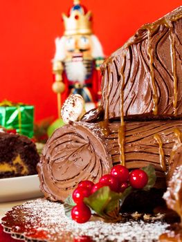 Traditional Christmas Yule Log cake decorated with marzipan mushrooms.