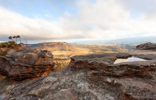 Mountain views to Megalong Valley with golden afternoon light, snow clouds coming across and strong winds.