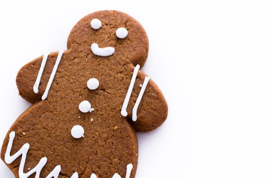 Homemade gingerbread cookies decorated with white icing on white background.