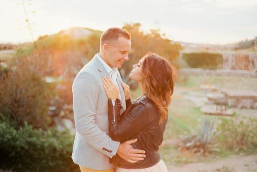 Bride put her hands on the chest of groom, hugging her waist. High quality photo