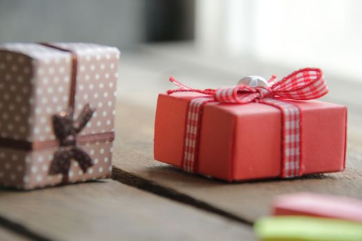 Gift with a ribbon on a beautiful wooden vintage background.