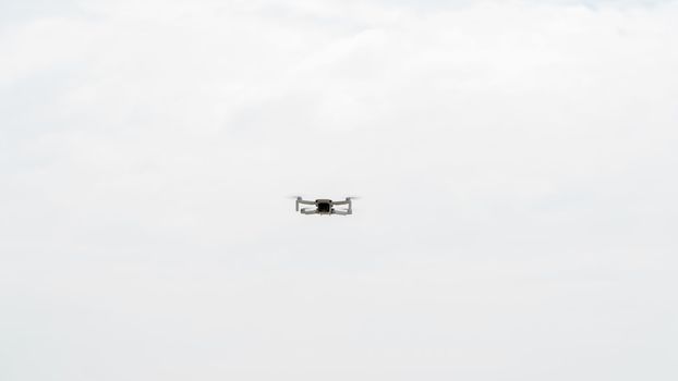 Small quadcopter hovered in the sky, aerial photography. High quality photo